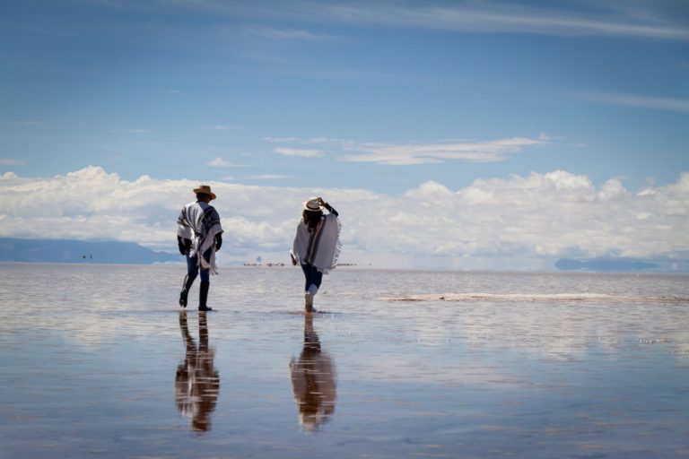 Young,Couple,Walking,In,The,Salt,At,The,Uyuni,In